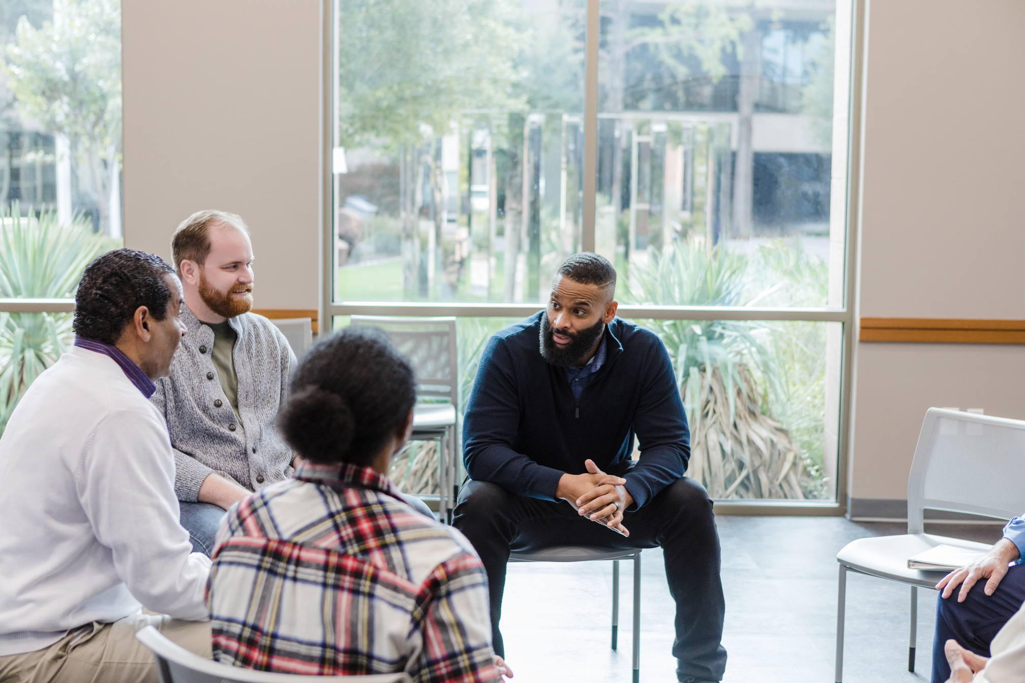 Diverse group of men talking